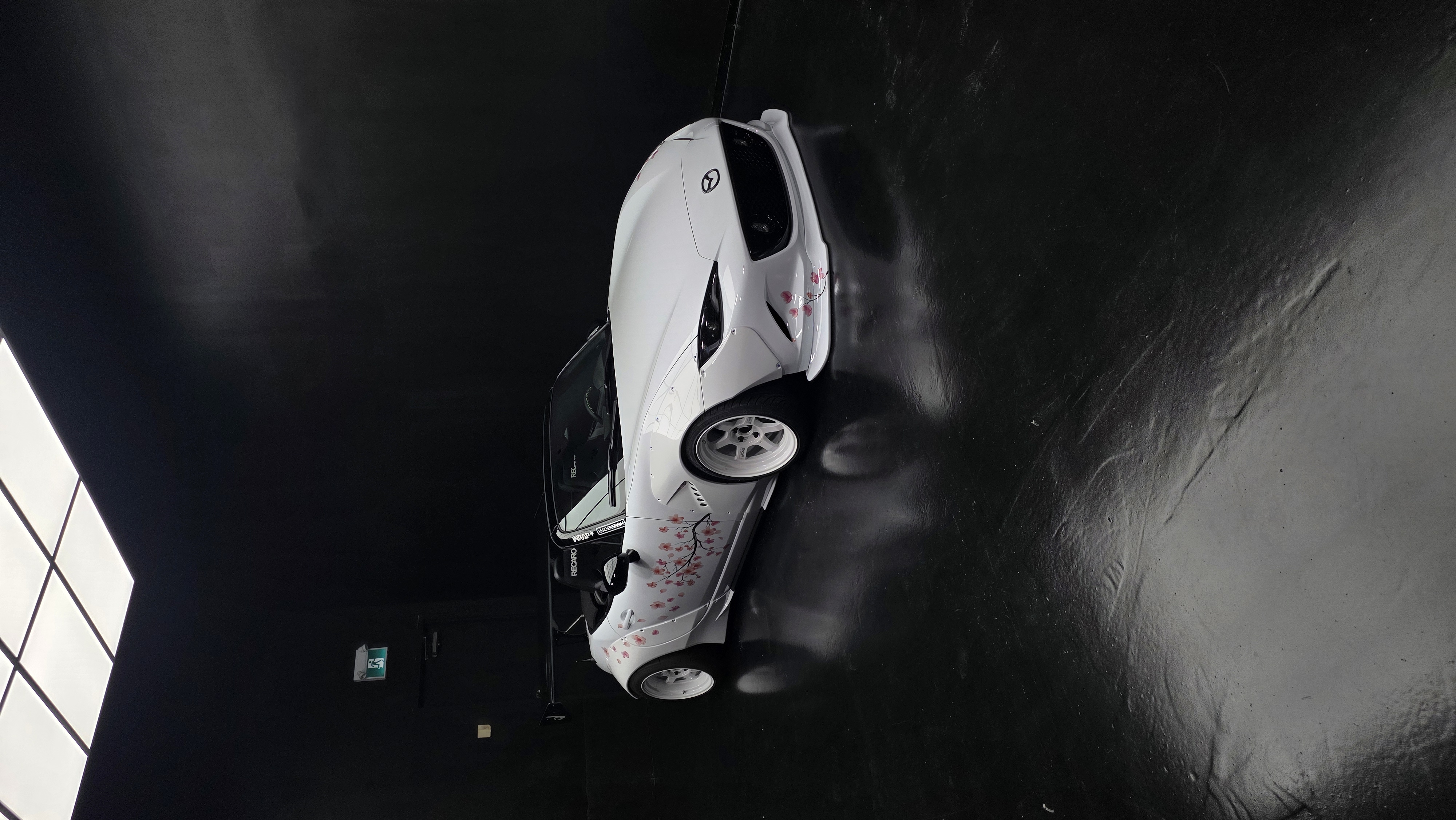 White roadster with cherry blossom graphics at the Wrap+ studio